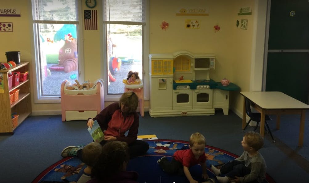 Person reading to children in a classroom