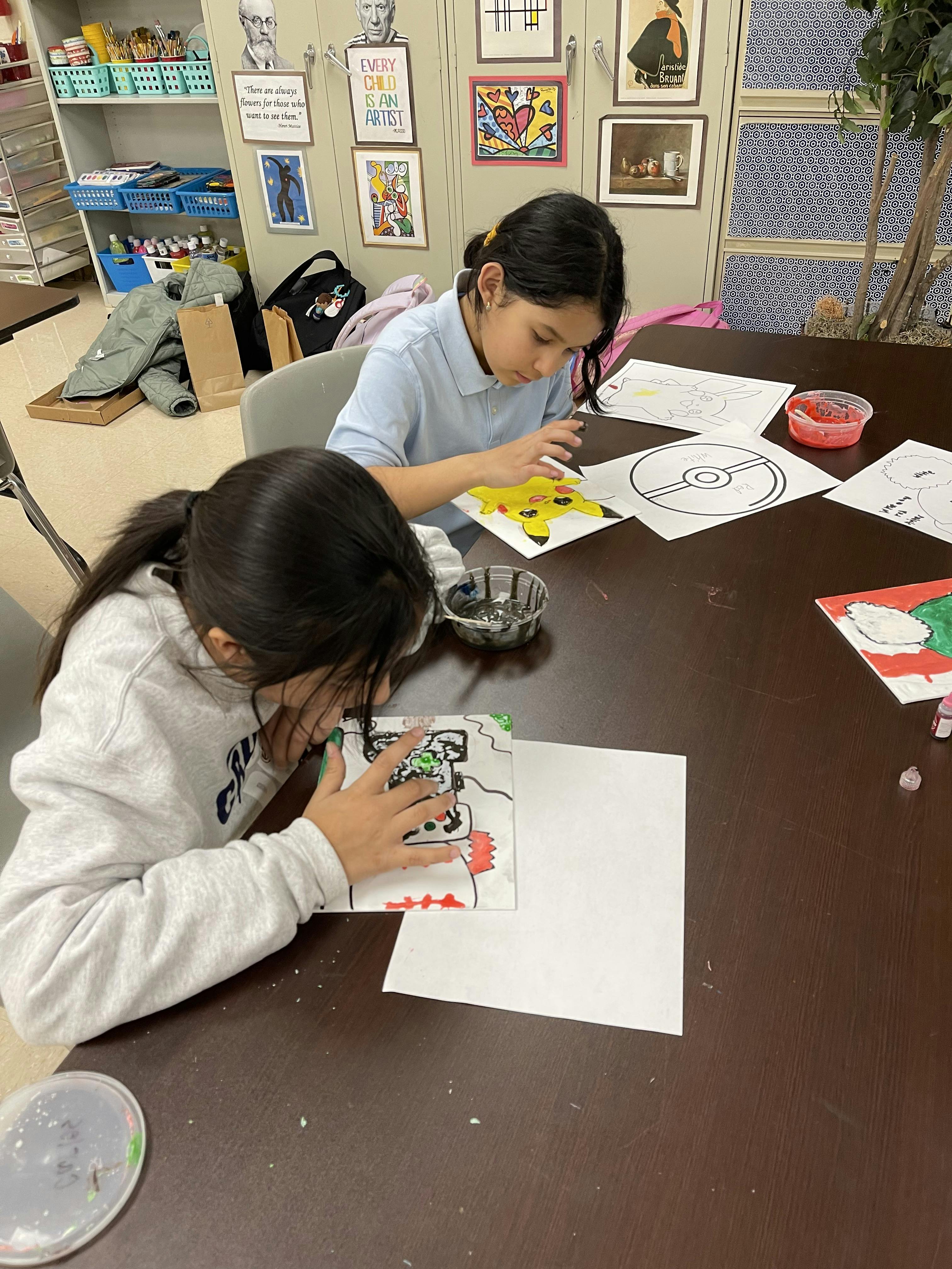 Two children drawing and coloring at a table