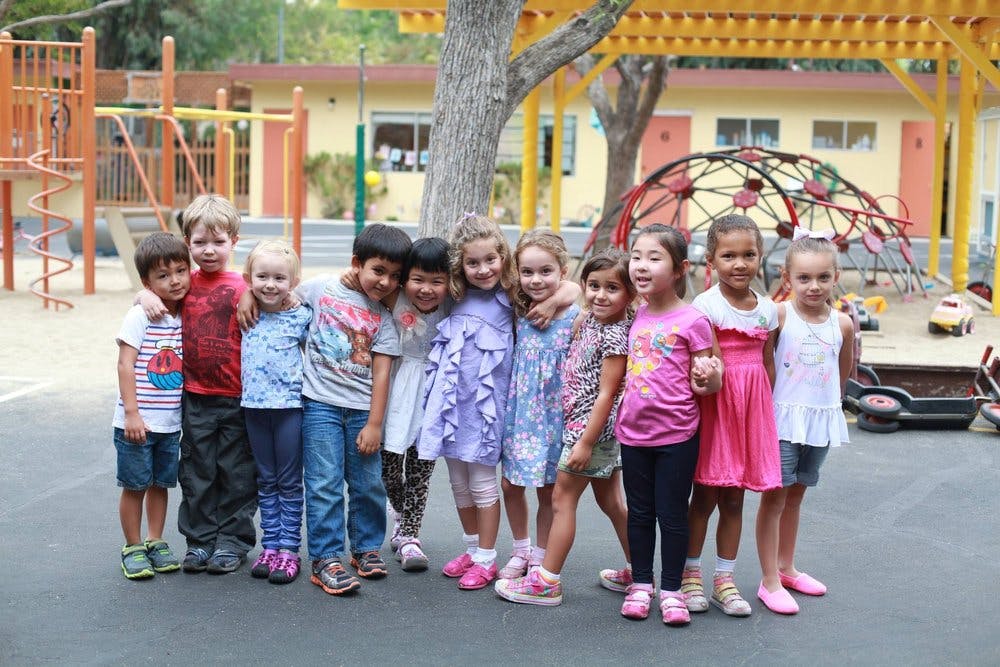 Group of diverse children standing together on a playground