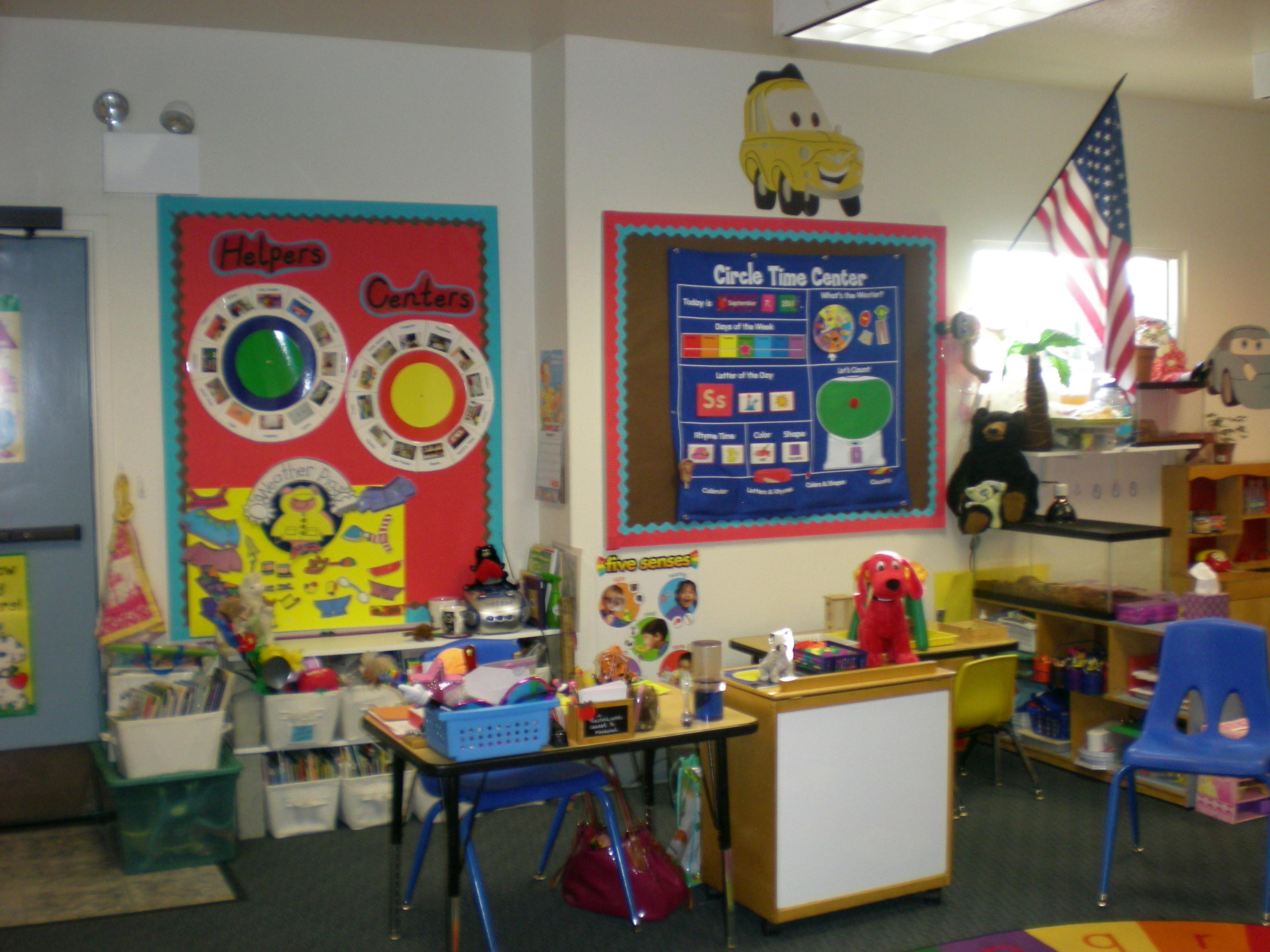 Classroom with colorful bulletin boards, small tables, and chairs