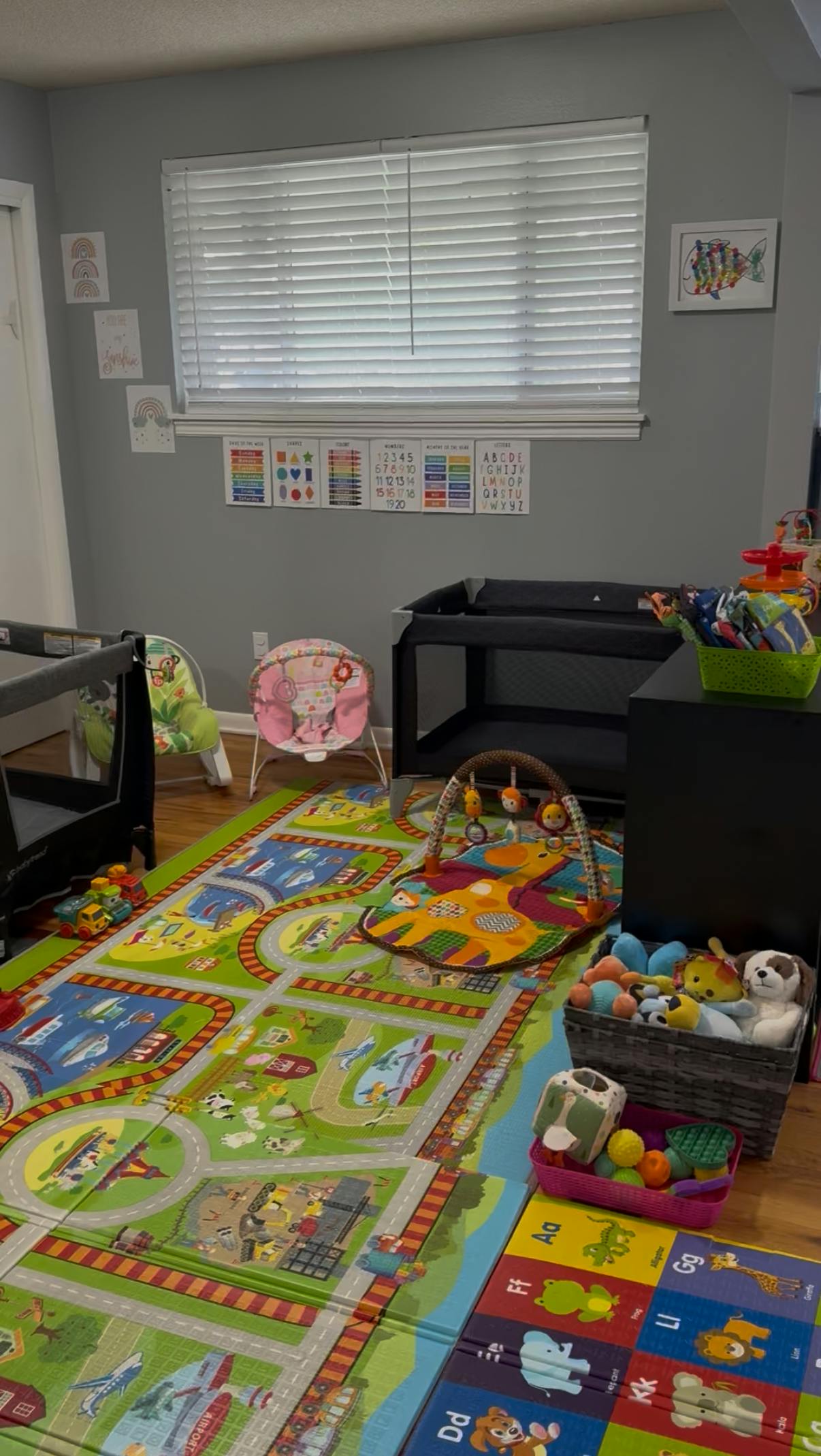 Nursery room with playmat, baby bouncer, and changing table