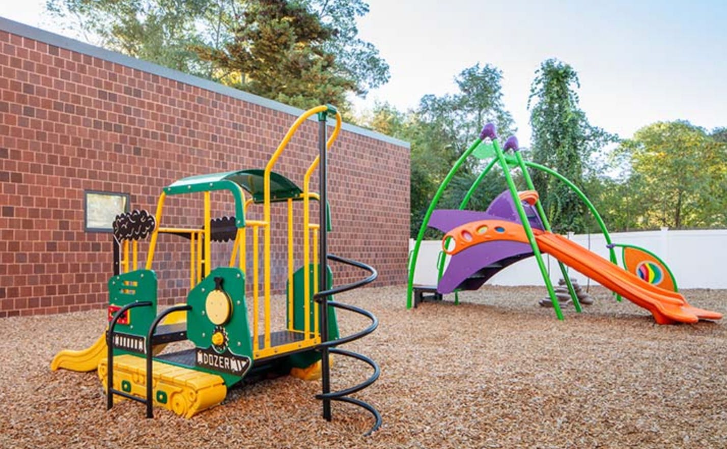 Playground with a train-shaped structure and a slide