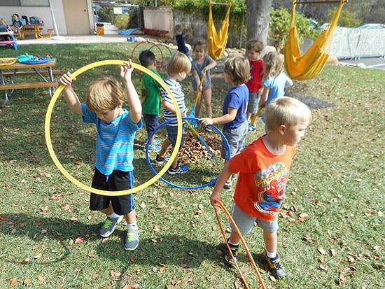 Children playing with hula hoops outdoors