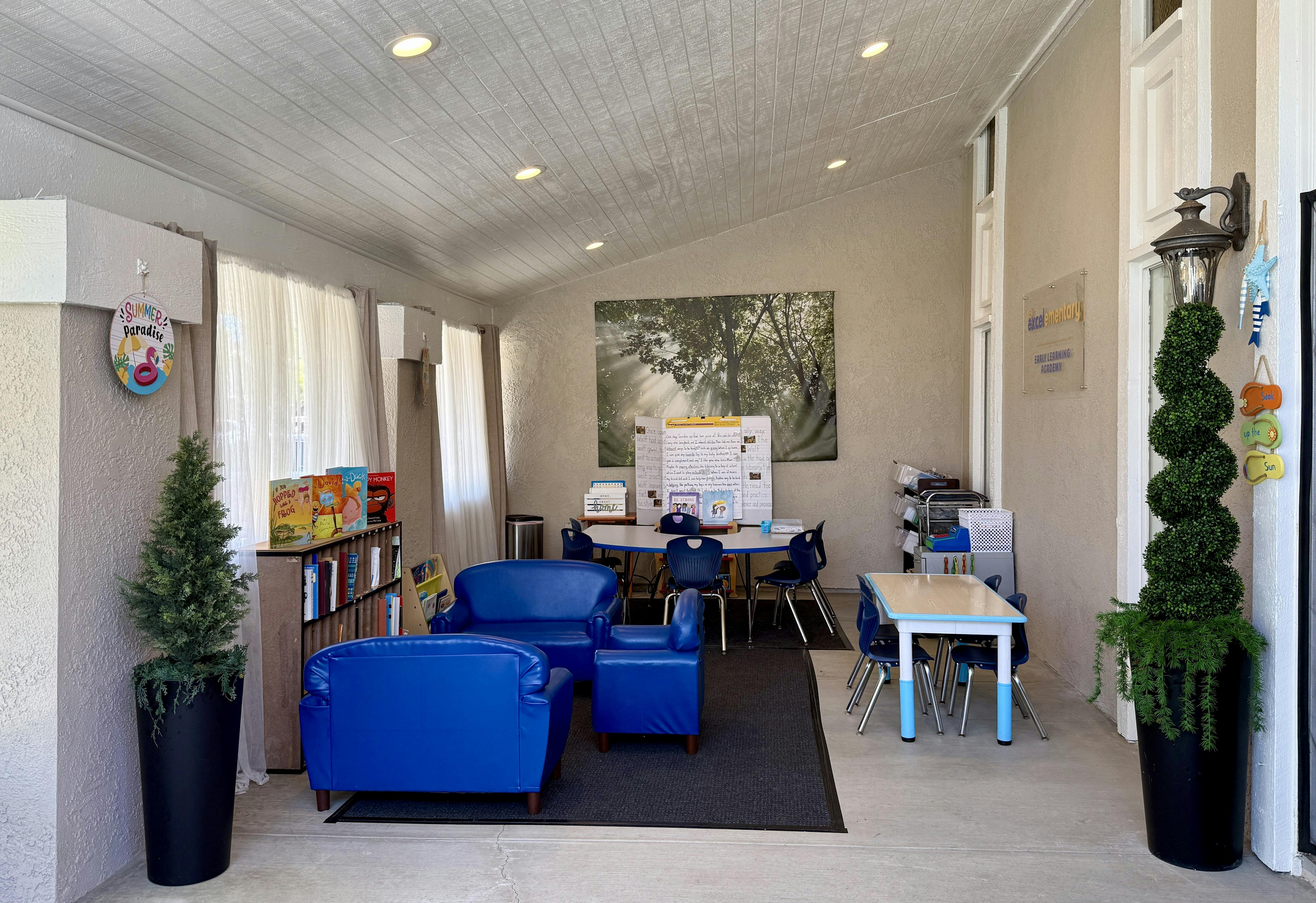 Classroom interior with small blue chairs tables and children books