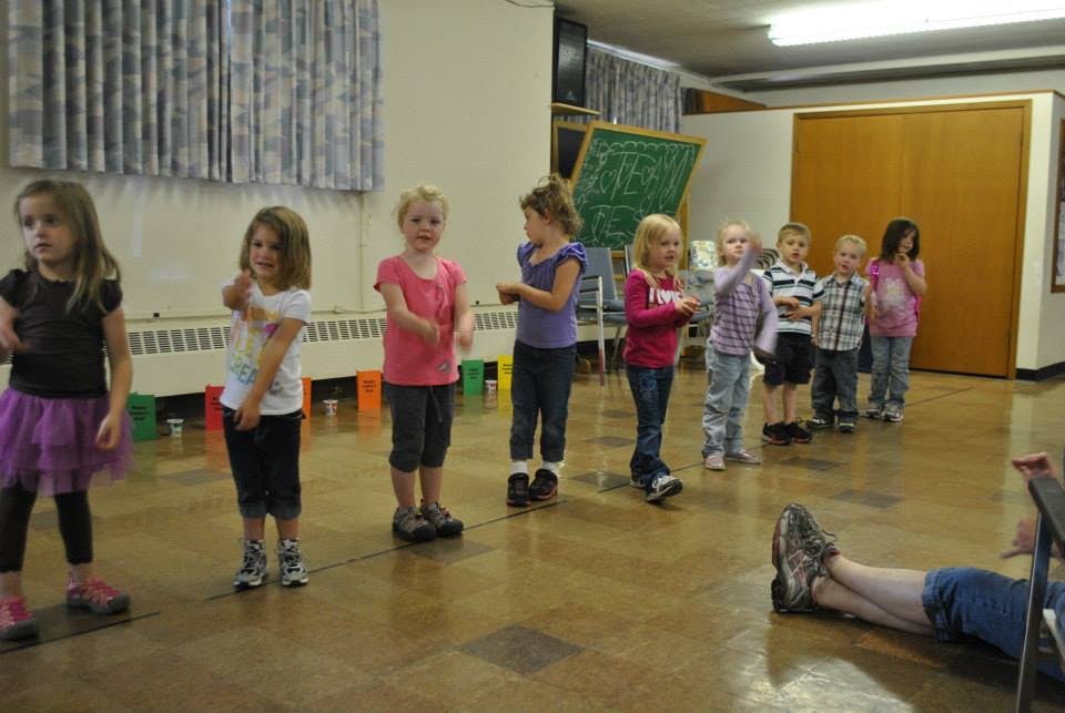 Group of children standing in a line indoors