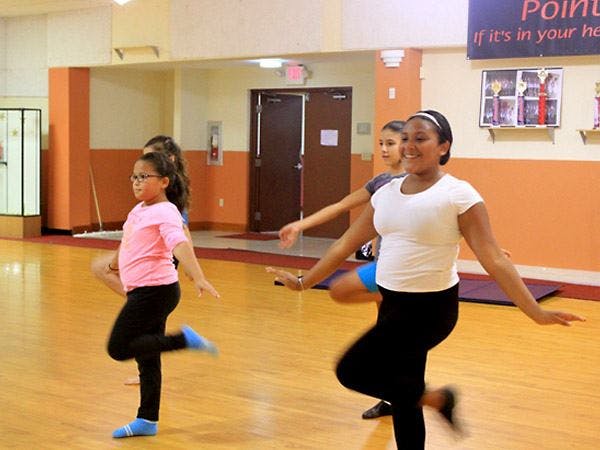 Three people dancing in a studio