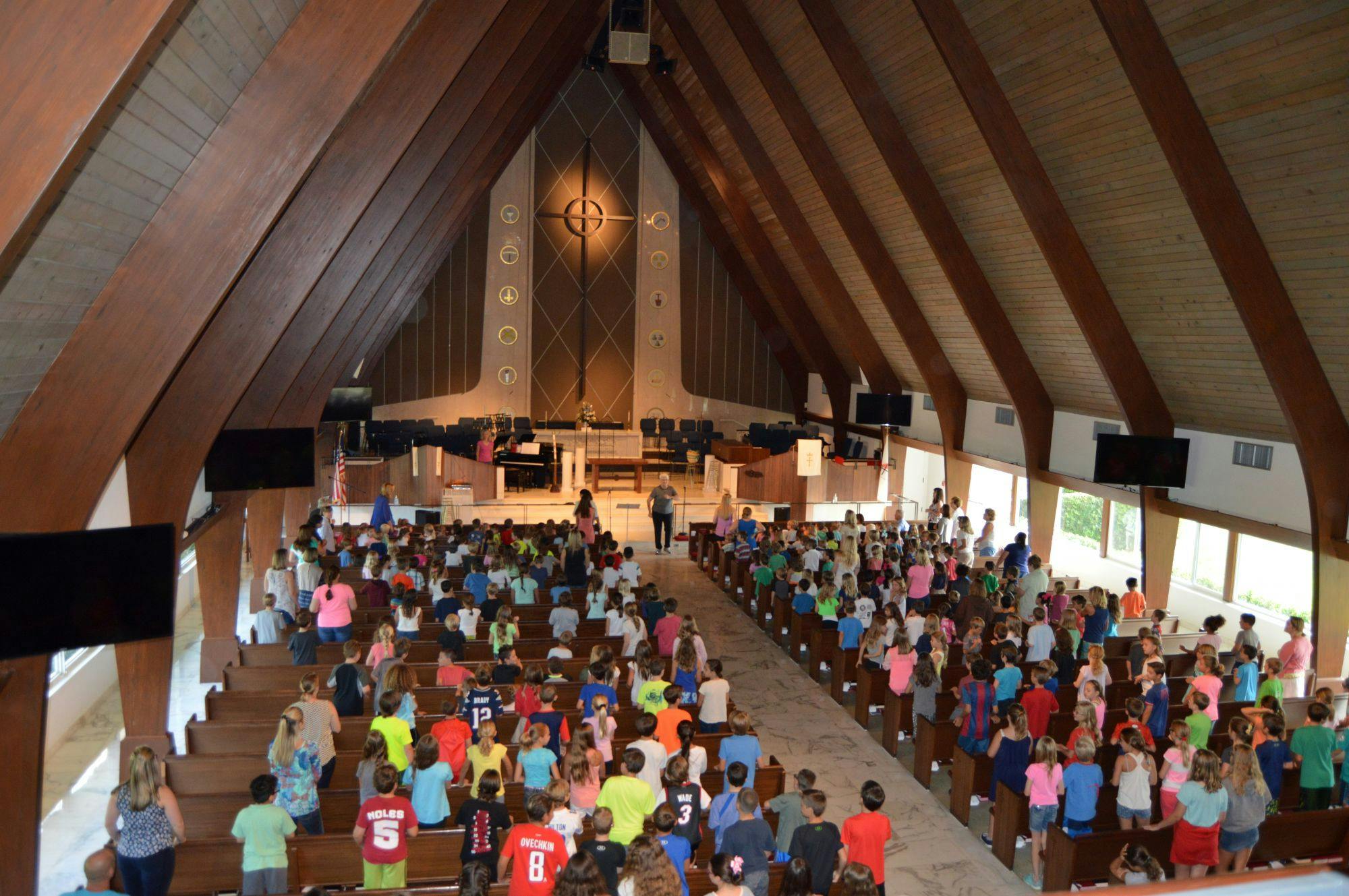 Large group of children and adults gathered in a church
