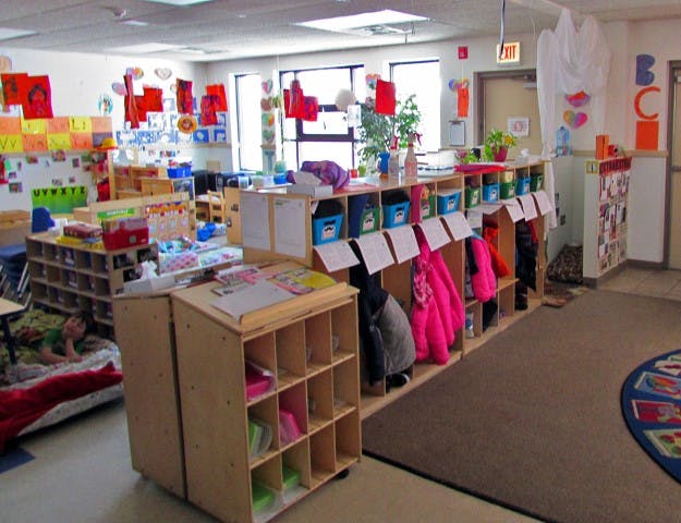 Classroom with cubbies, shelves, and colorful decorations
