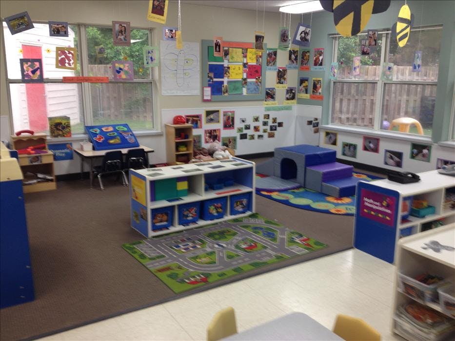 Classroom filled with toys, child-sized furniture, and colorful decorations