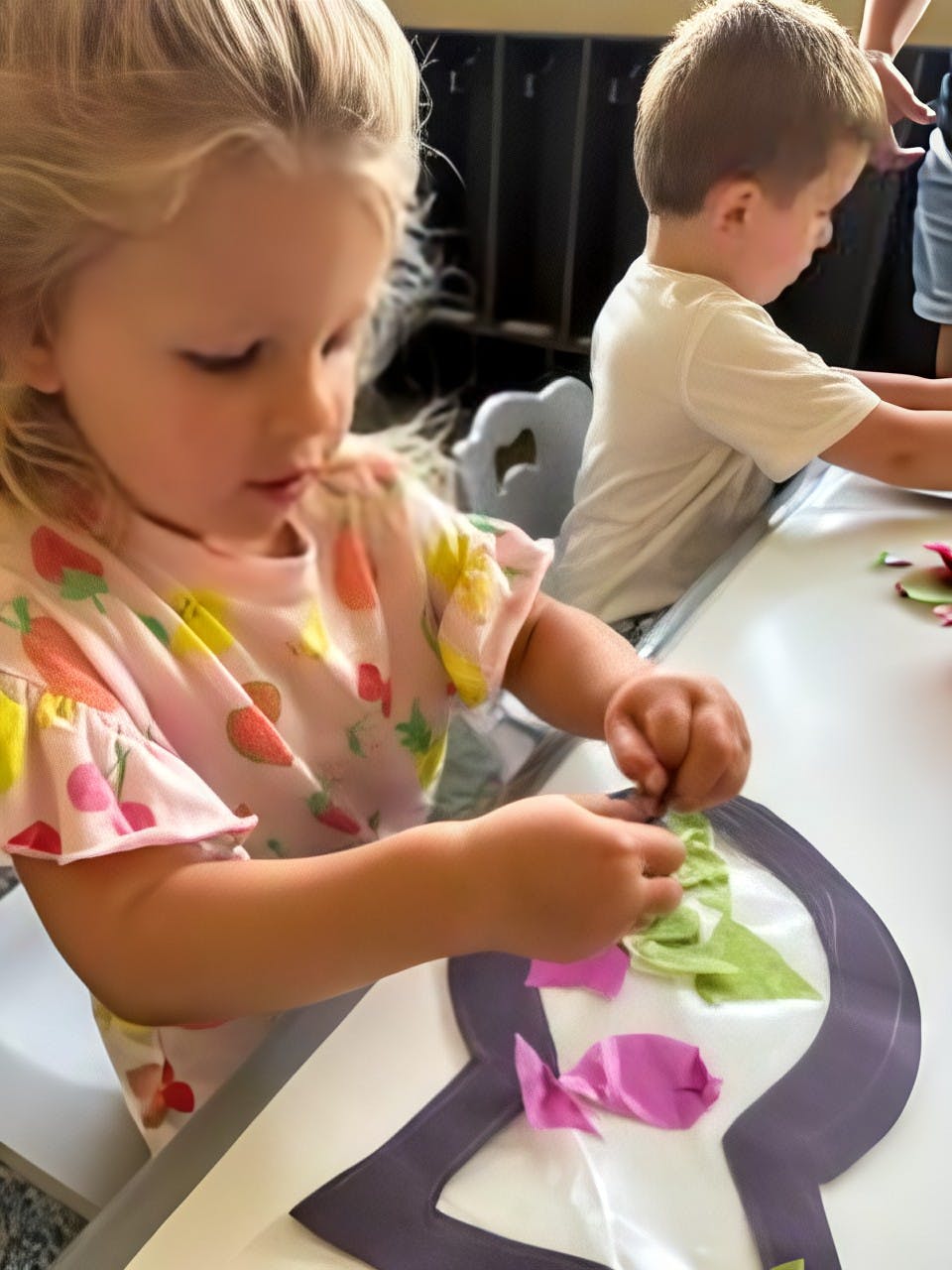 Child doing a craft at a table