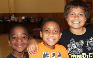 Three children smiling