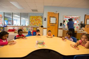 Children sitting at a table in a classroom