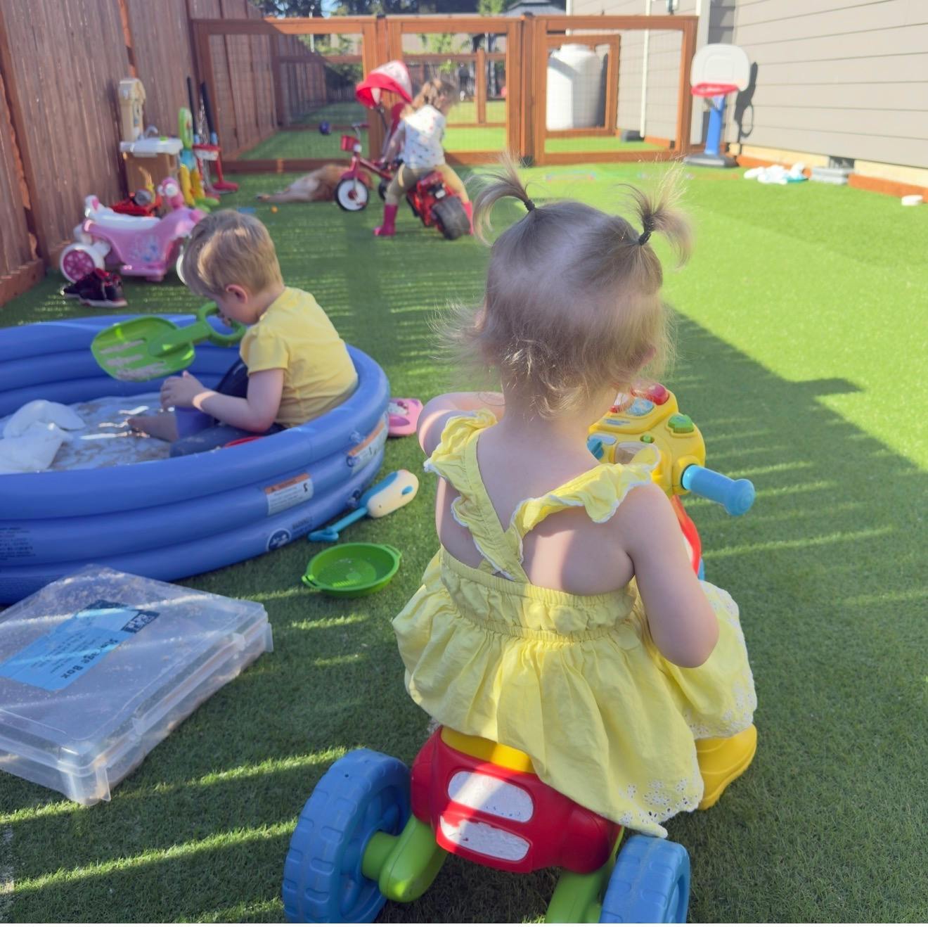 Children playing with toys and a pool in a backyard