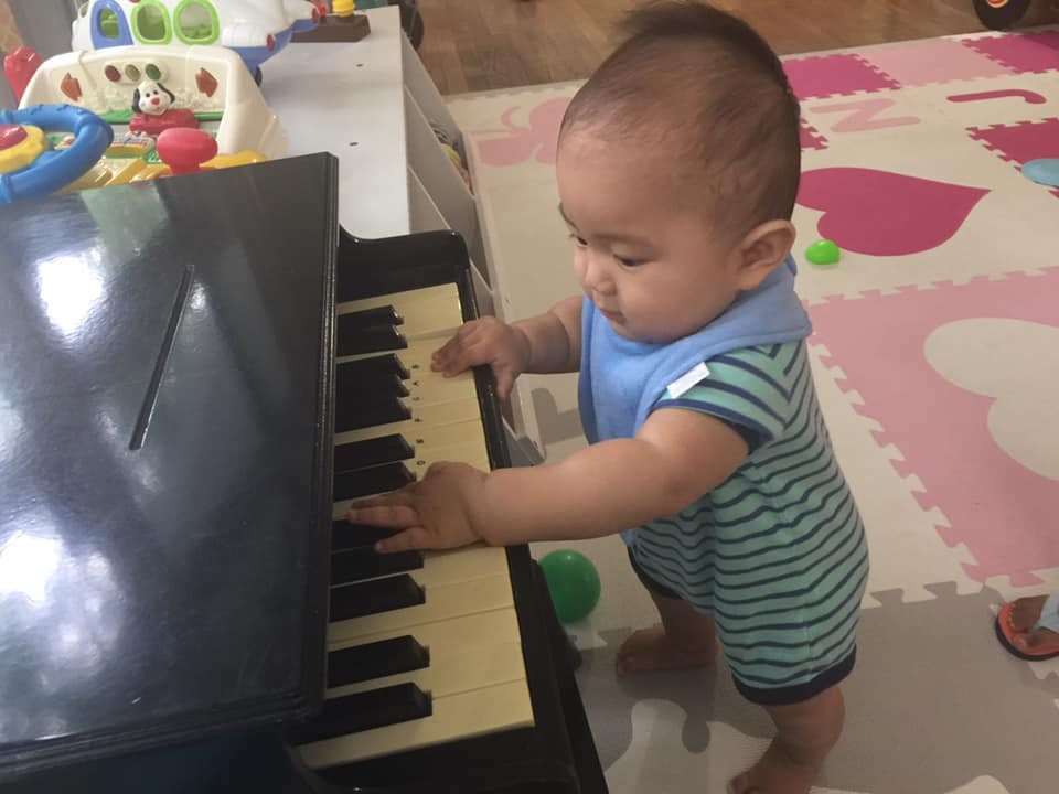 Child playing with a toy piano