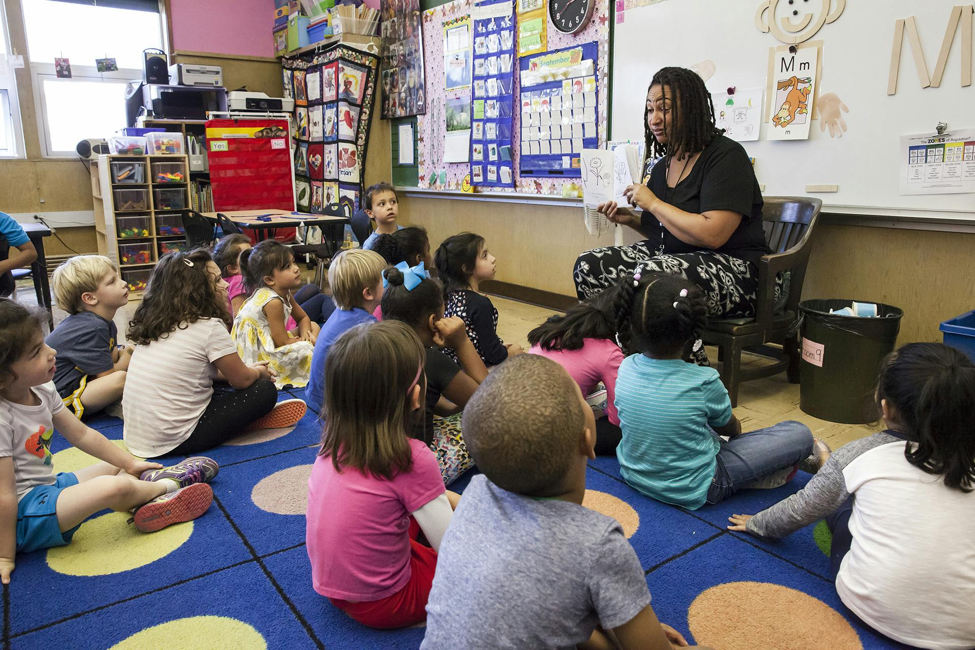 Person reading to children in a classroom