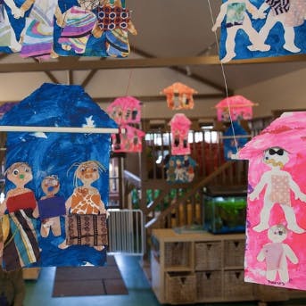 Child artwork hanging from a ceiling