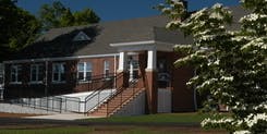Brick building with a front entrance, stairs, and a ramp