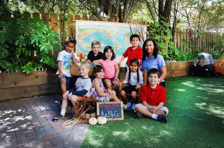 Adult and children posing for a group photo outdoors