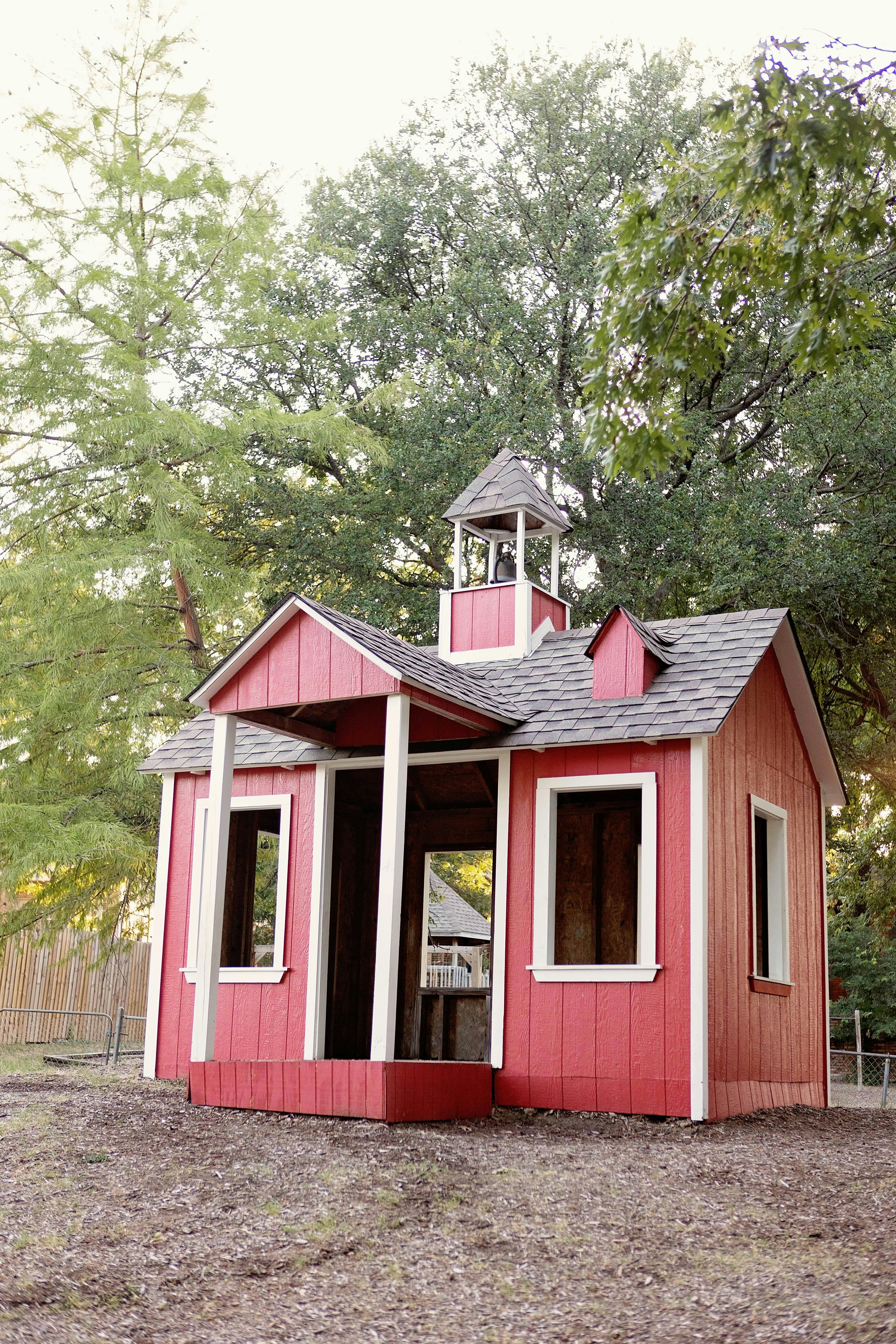 Red playhouse with a small bell tower