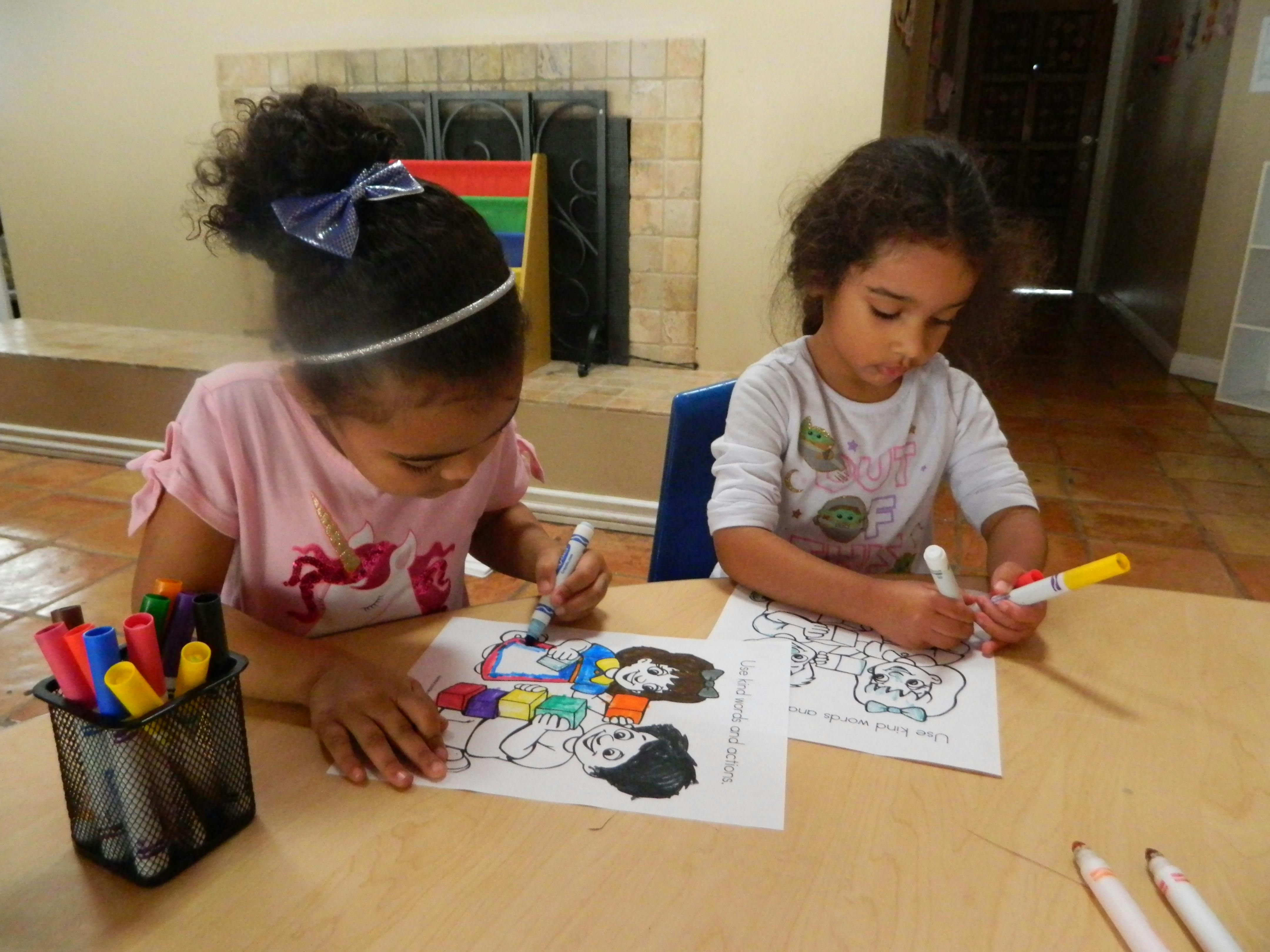 Two children coloring at a table