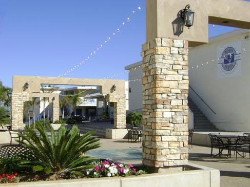 Outdoor courtyard with stone pillars and string lights