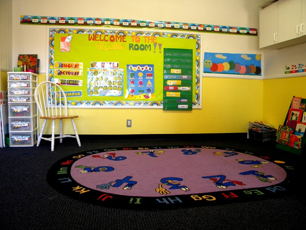 Classroom with a bulletin board and an alphabet rug