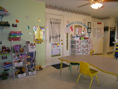 Child's playroom with toys, tables, and chairs