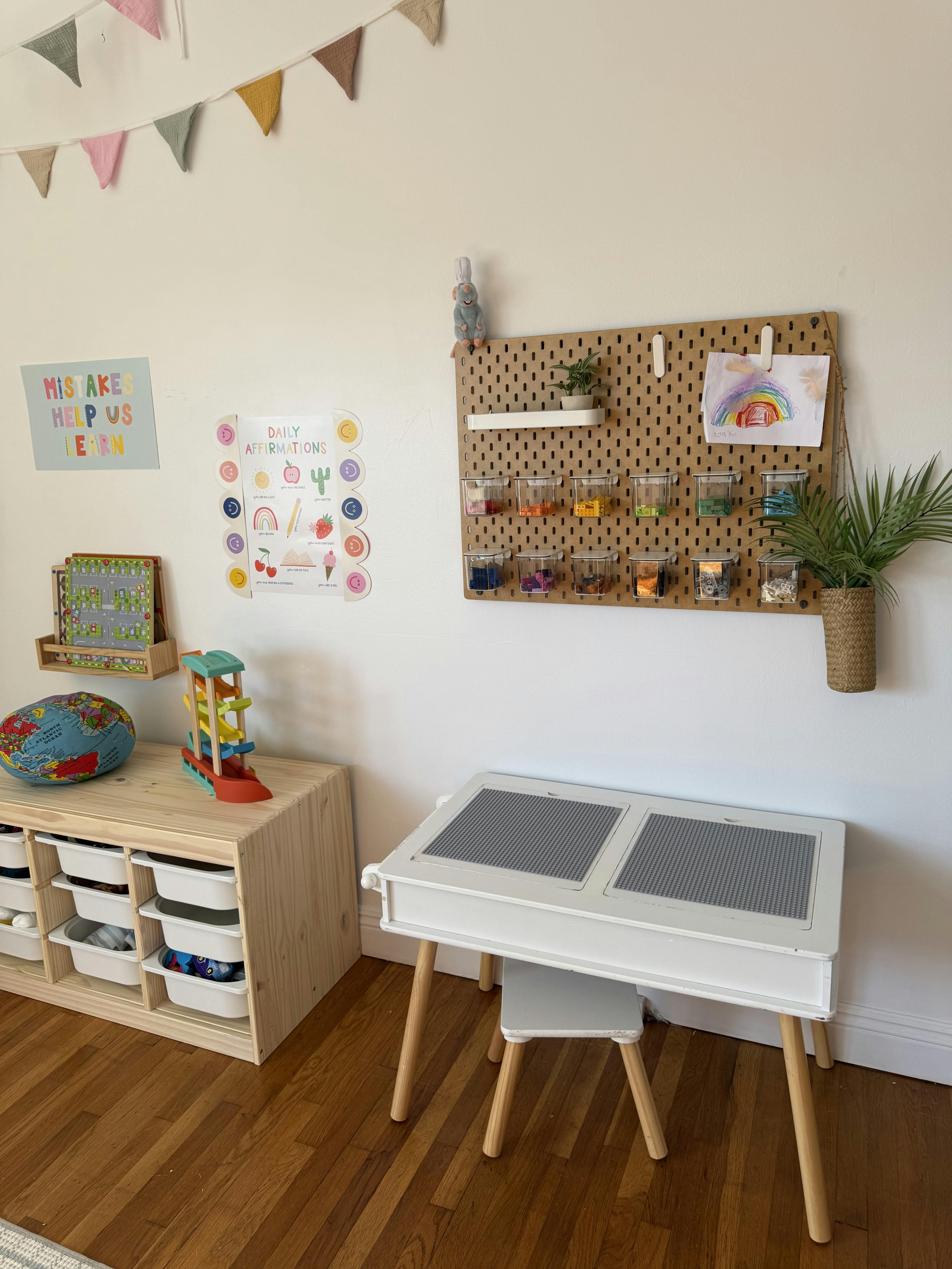 Child's play area with a small table and storage unit