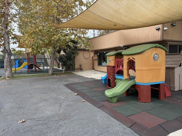 Empty children's playground with multiple slides and climbing structures