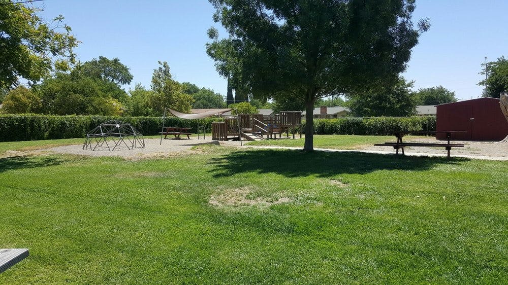 Playground with climbing dome, play structure, and benches