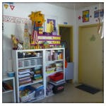 Shelves with various items in a room with a door
