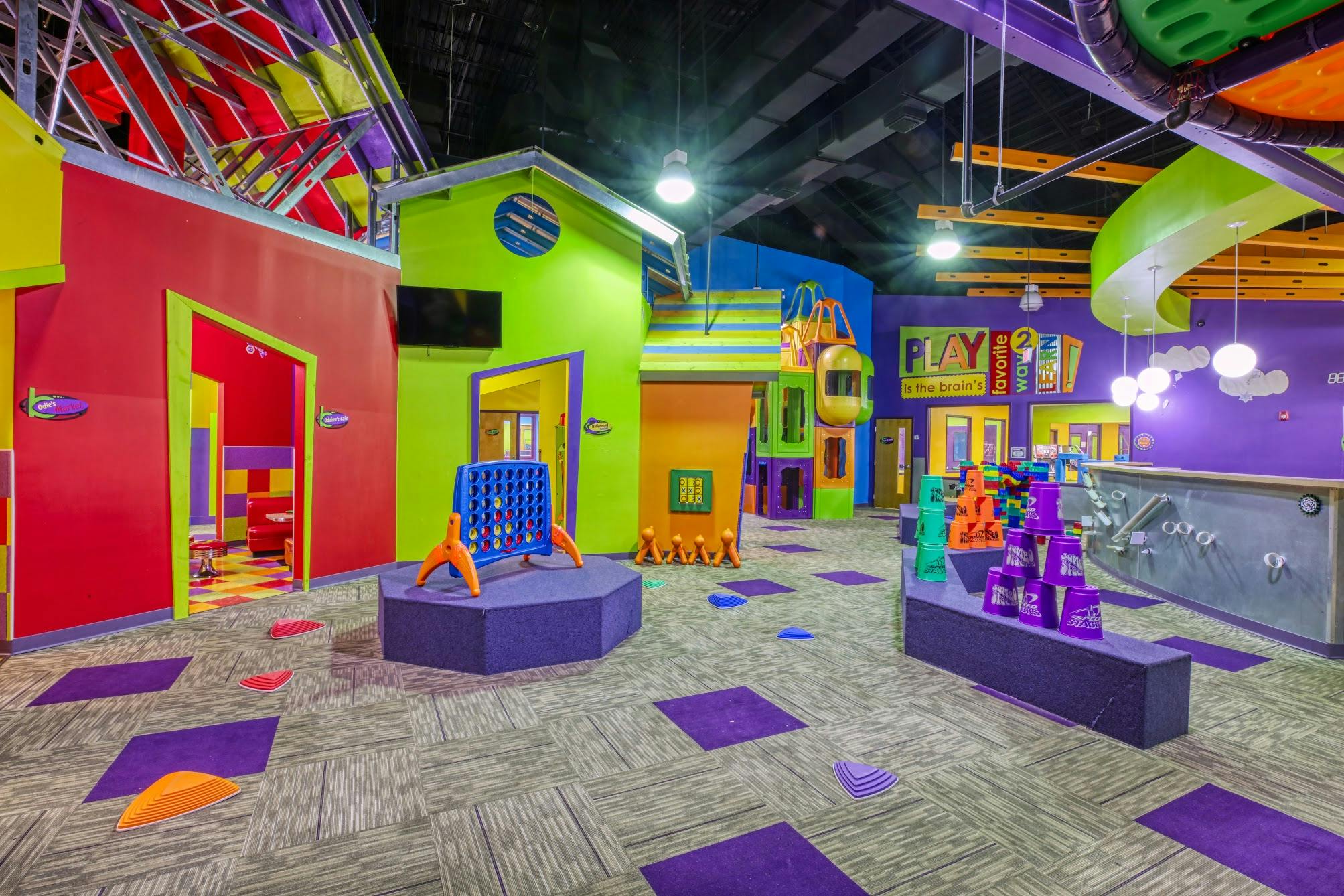 Indoor play area with colorful structures and games