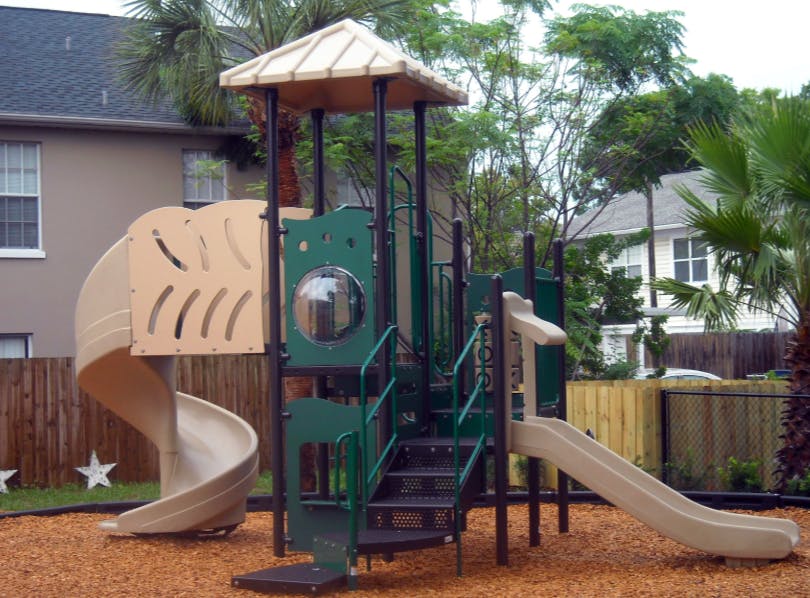 Playground structure with slides and stairs on wood chips