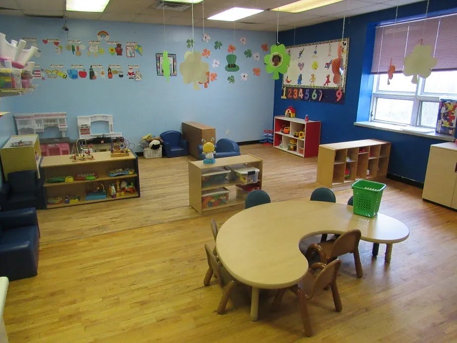 Empty classroom with tables, chairs, and shelves