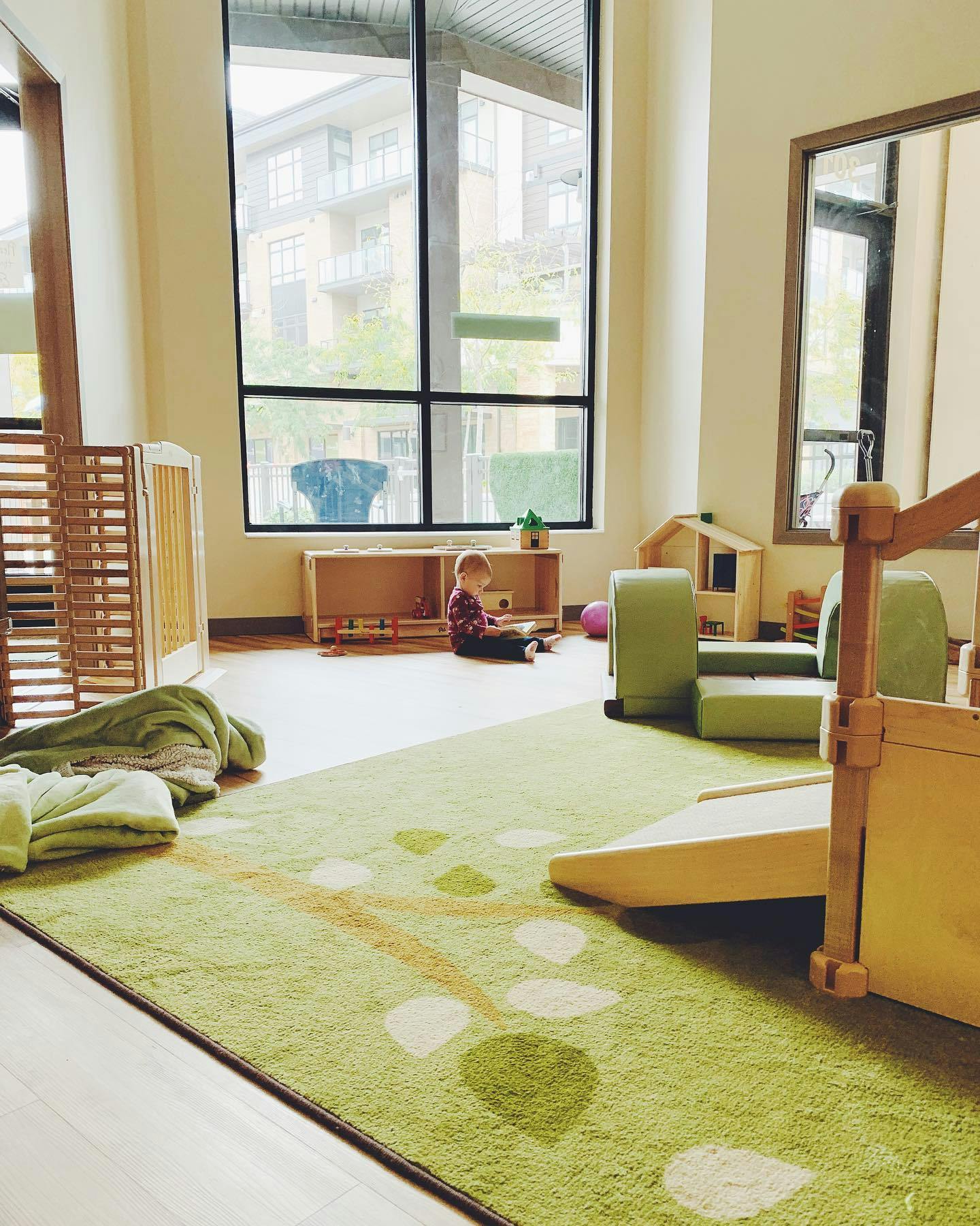 Child sitting on floor in a playroom