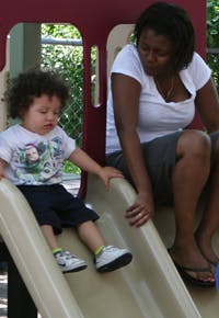Adult and child on a playground slide