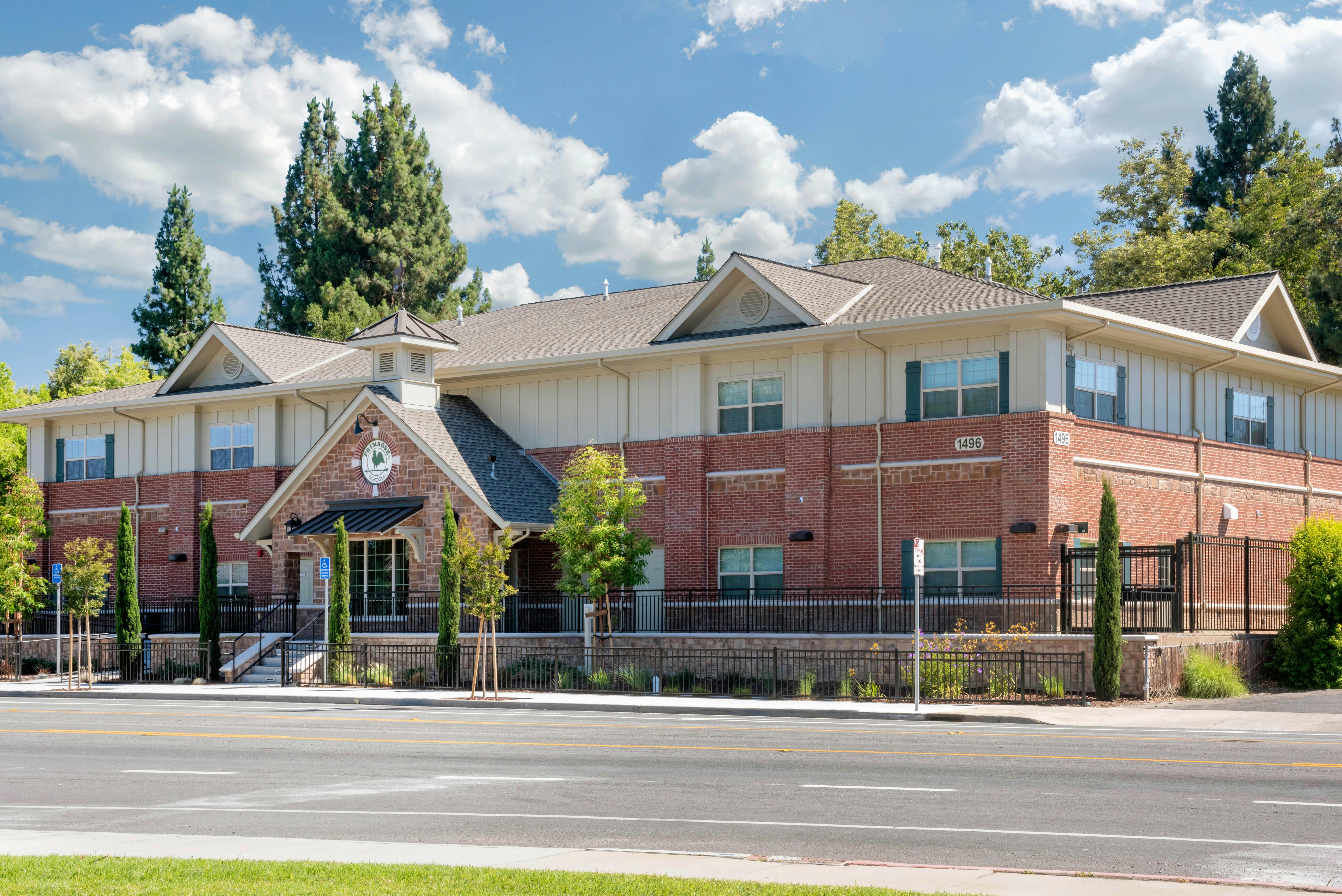 Multistory brick and beige building with a sign that says Primrose Schools