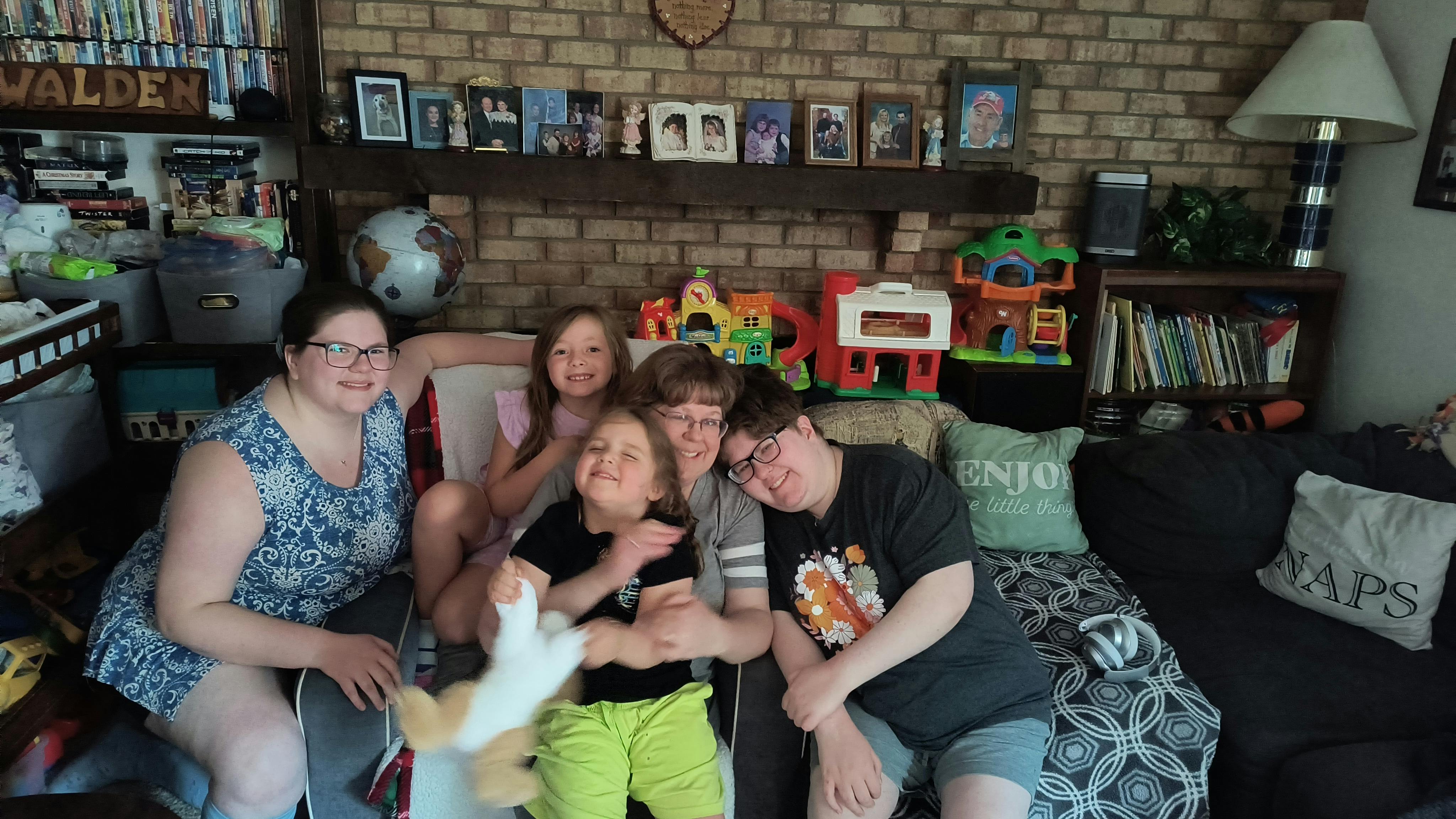 Group of people sitting together on a couch indoors