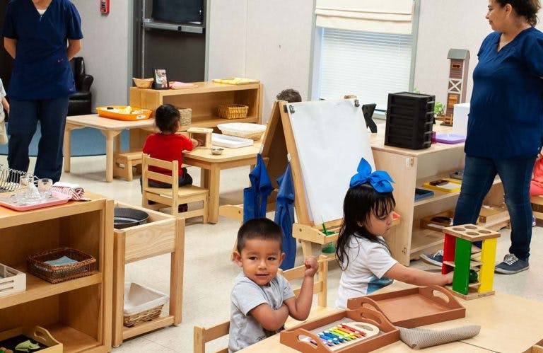 Children playing with toys and learning materials in a classroom
