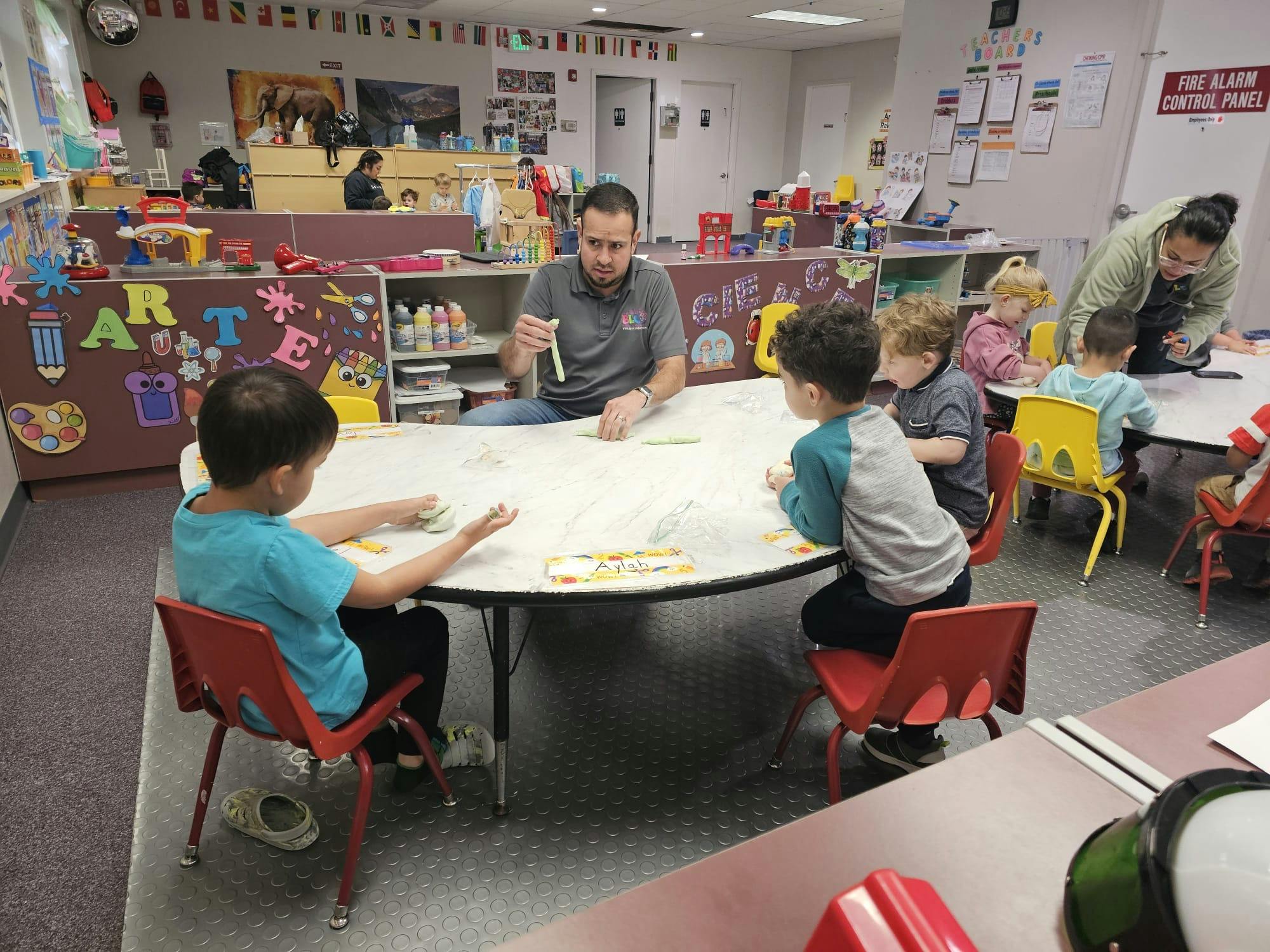Adult and children at a table in a classroom