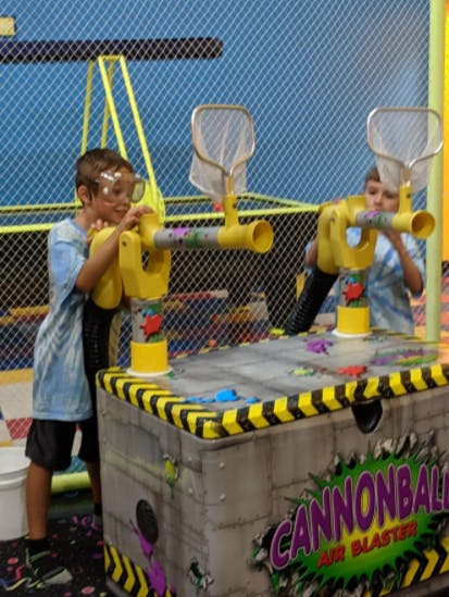 Two children playing with air blaster cannons