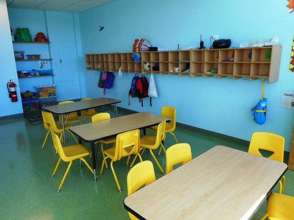 Classroom with small tables and yellow chairs