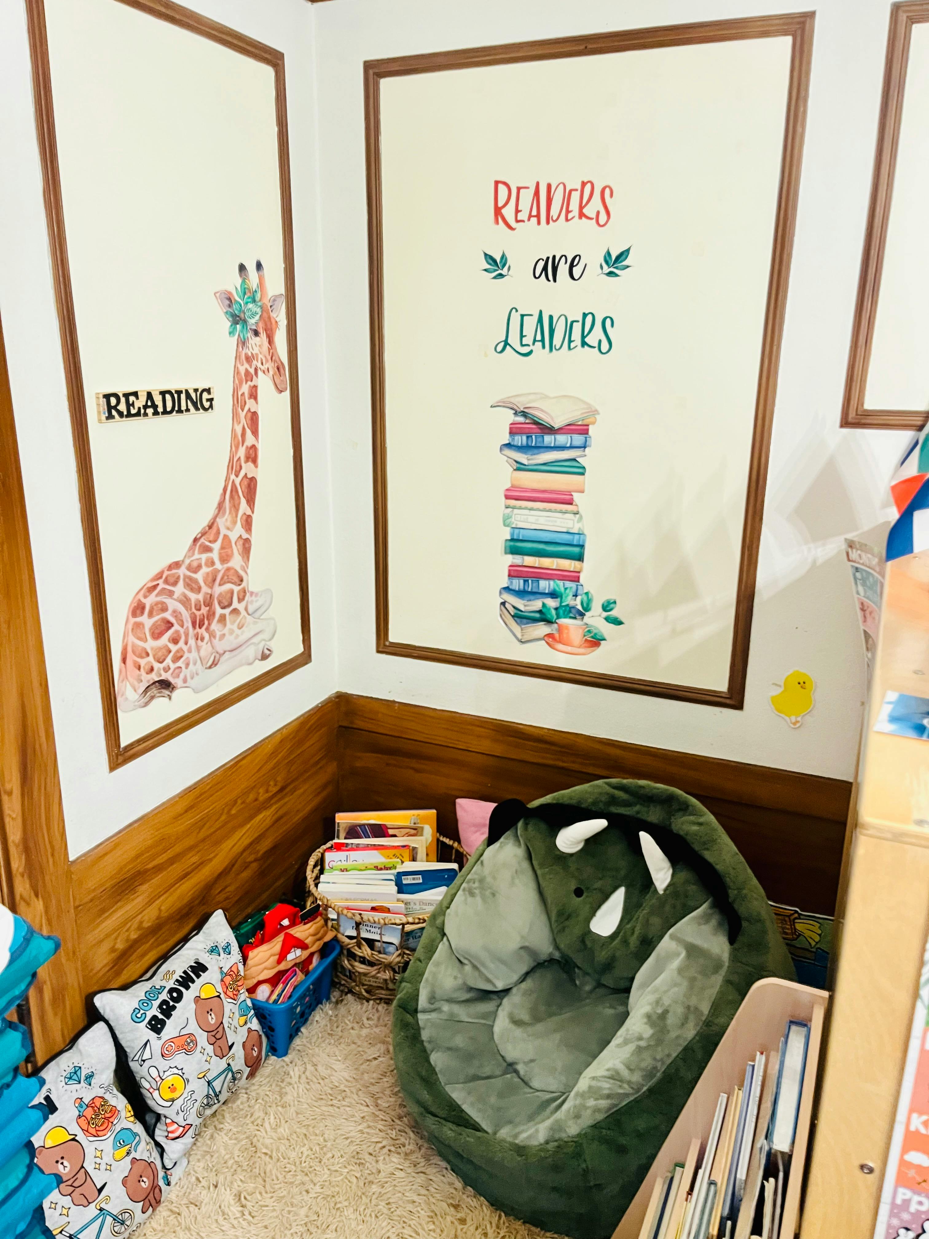 Reading nook with a dinosaur beanbag chair and framed wall art