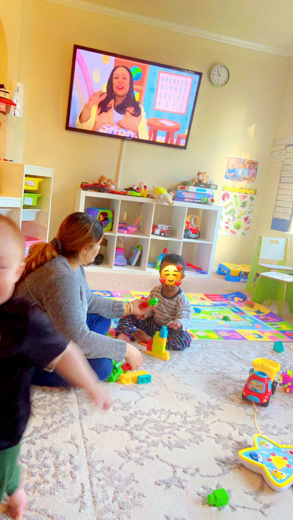 Person and child playing with toys on the floor