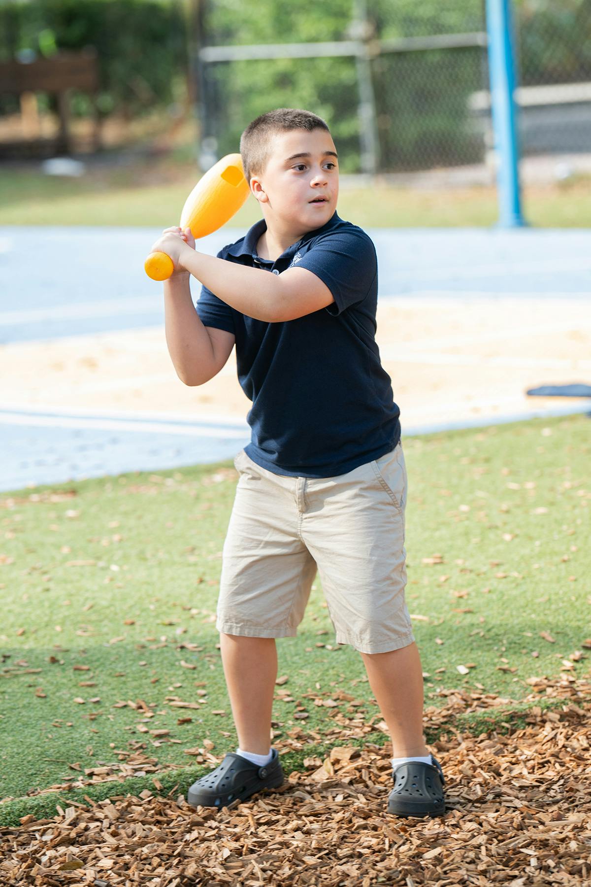 Child holding a yellow plastic bat
