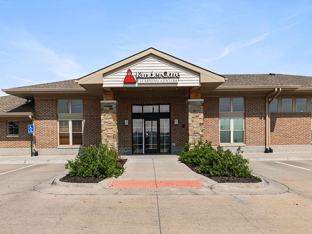 Brick building with a KinderCare Learning Centers sign above the entrance