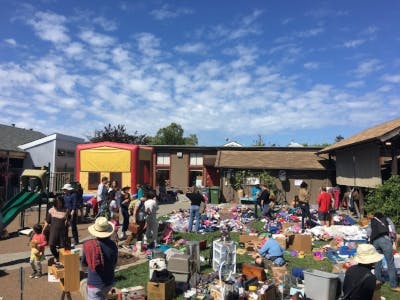 People browsing items at an outdoor market or yard sale