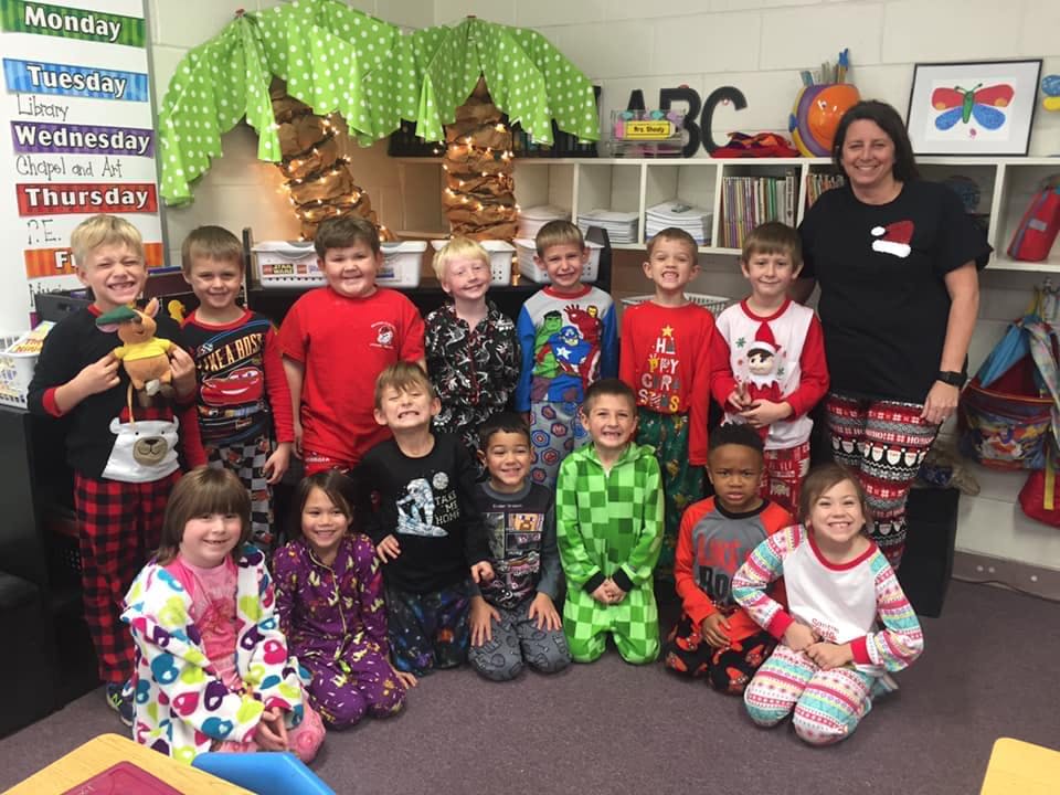 Teacher and children in pajamas in a classroom