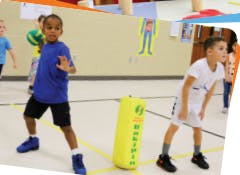 Two children playing with a yellow punching bag