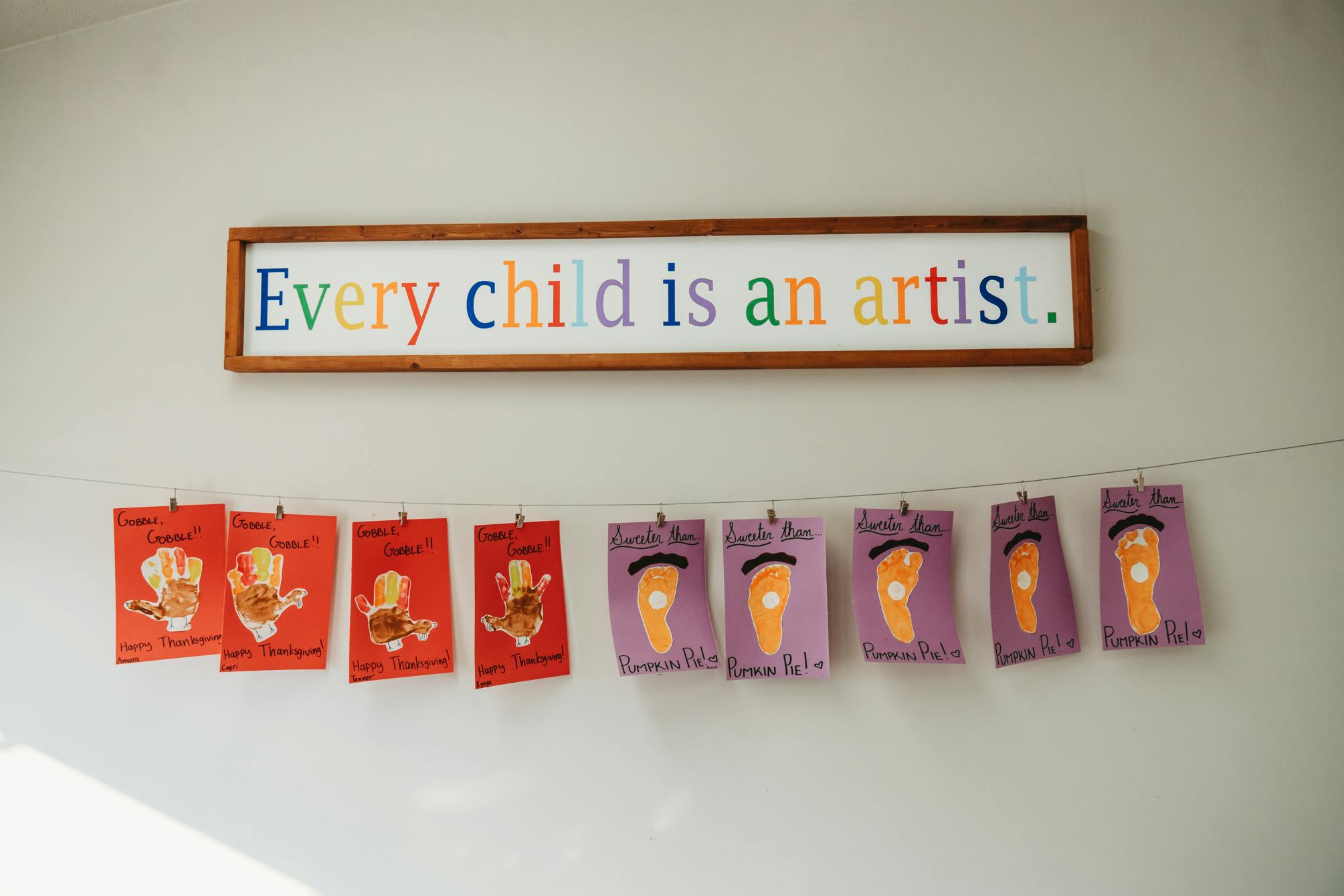 Wall decoration with text and children's artwork
